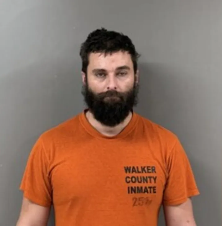 Mugshot of Jameson Boley in an orange shirt with 