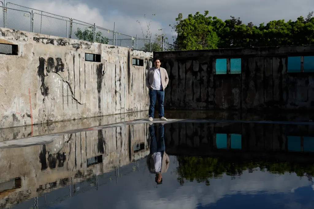 Jeremy Padawer stands in what remains of his home nearly a year after the Palisades fires.