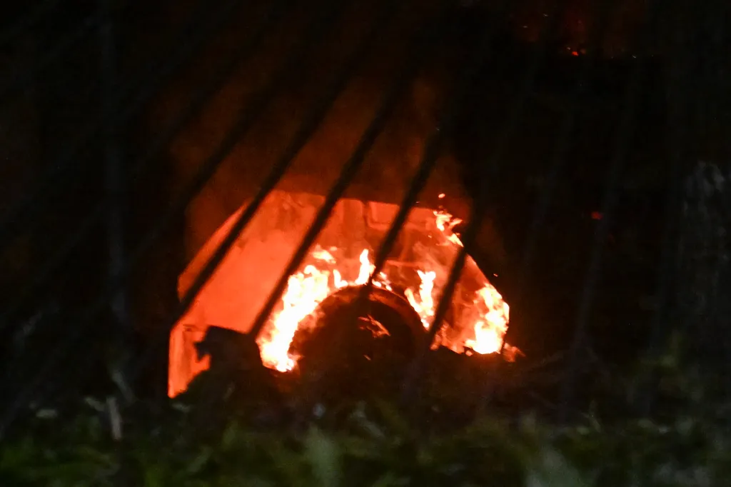 A vehicle burns at La Carlota air base after a US airstrike on the South American country.