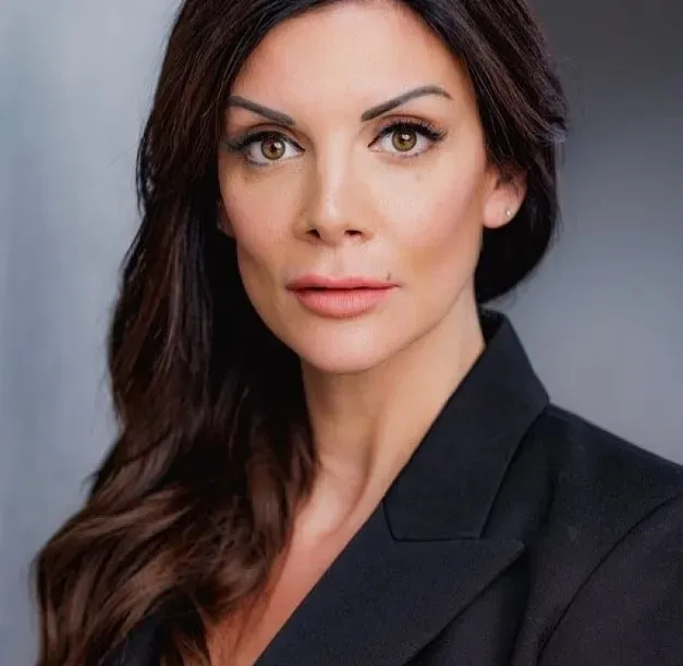 Jessica Moretti with long dark hair and a black blazer.