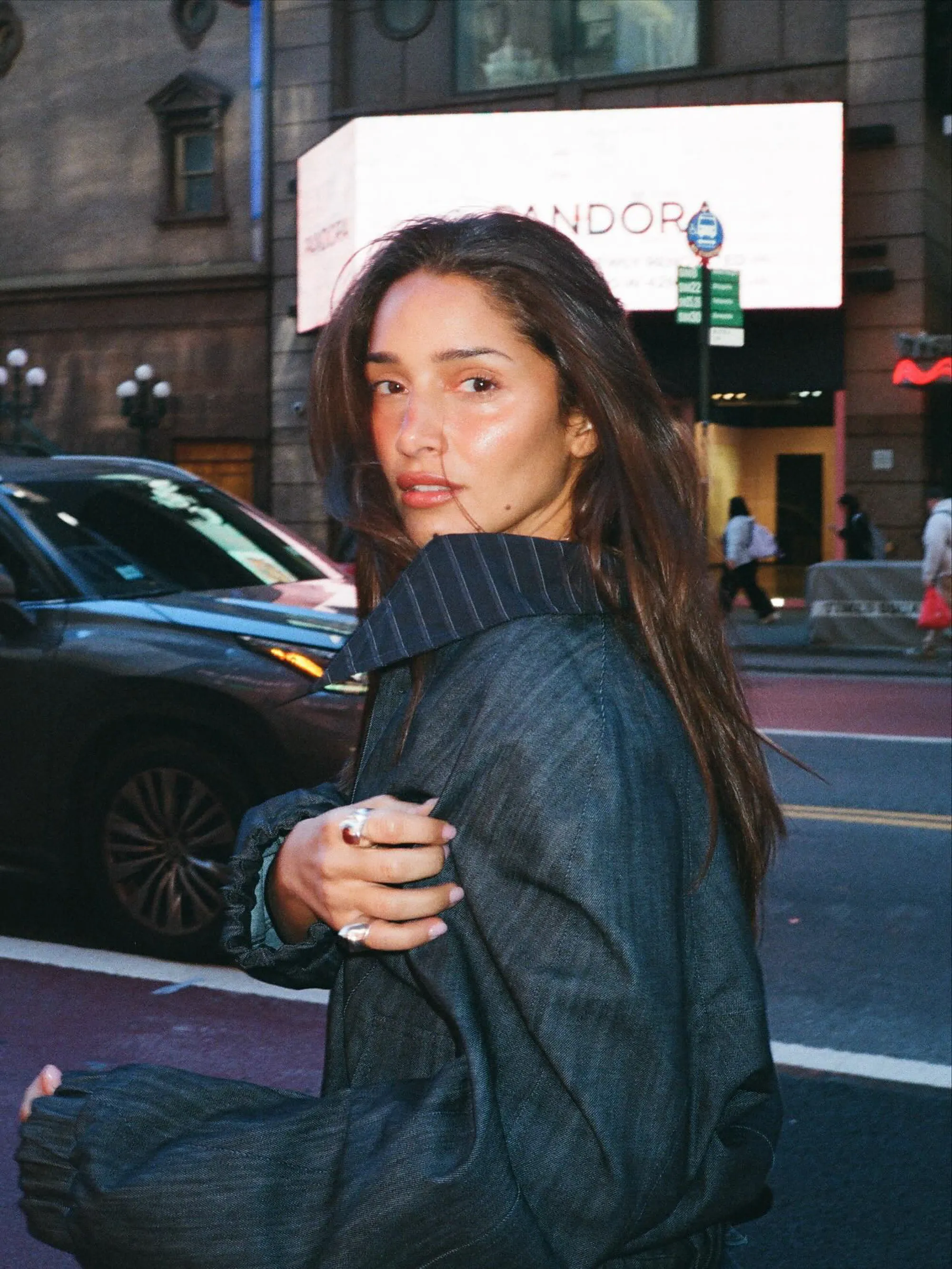 Model Tatiana Gabriela looking over her shoulder with an urban background.