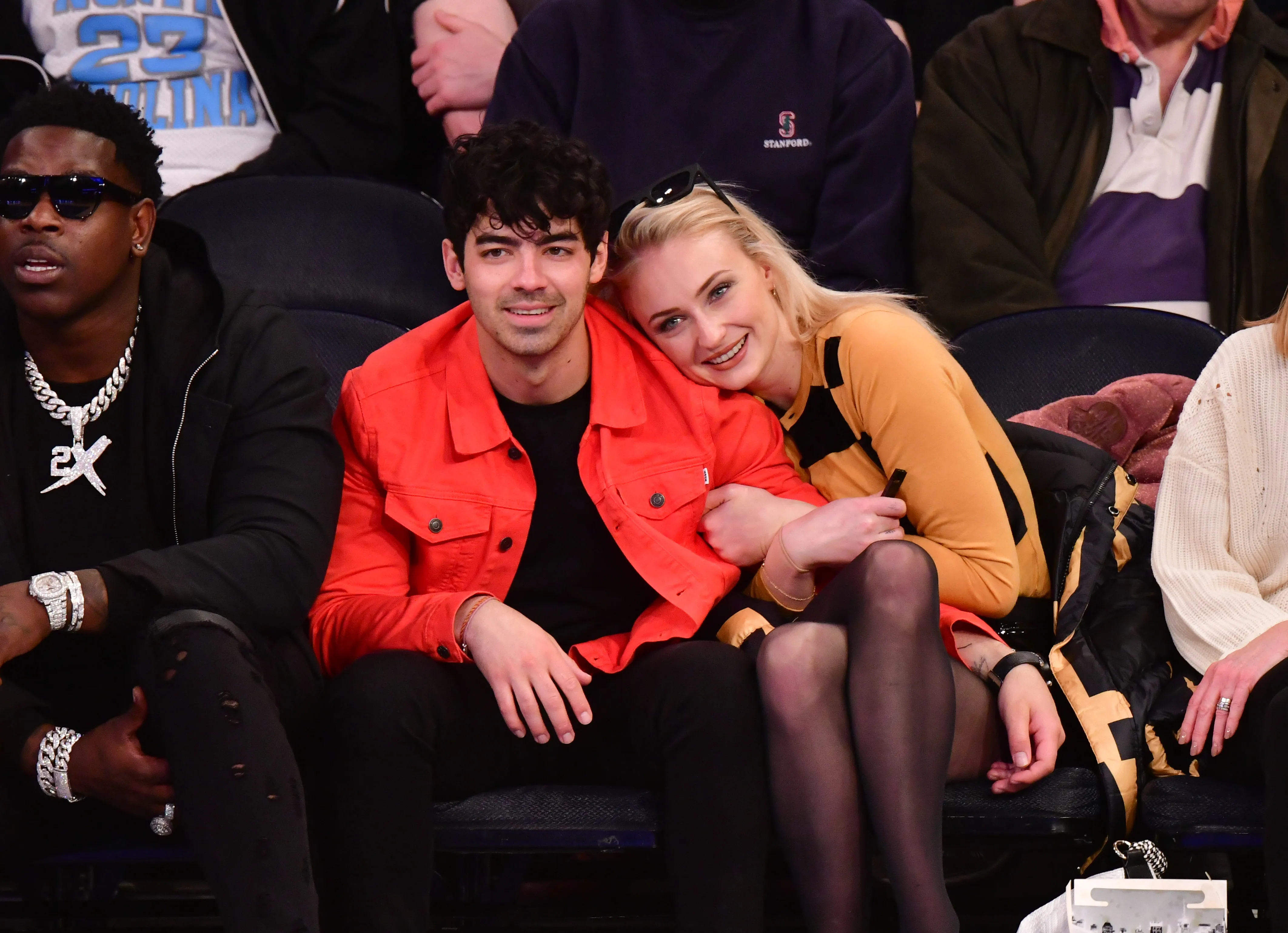 Joe Jonas and Sophie Turner sitting courtside at a basketball game.