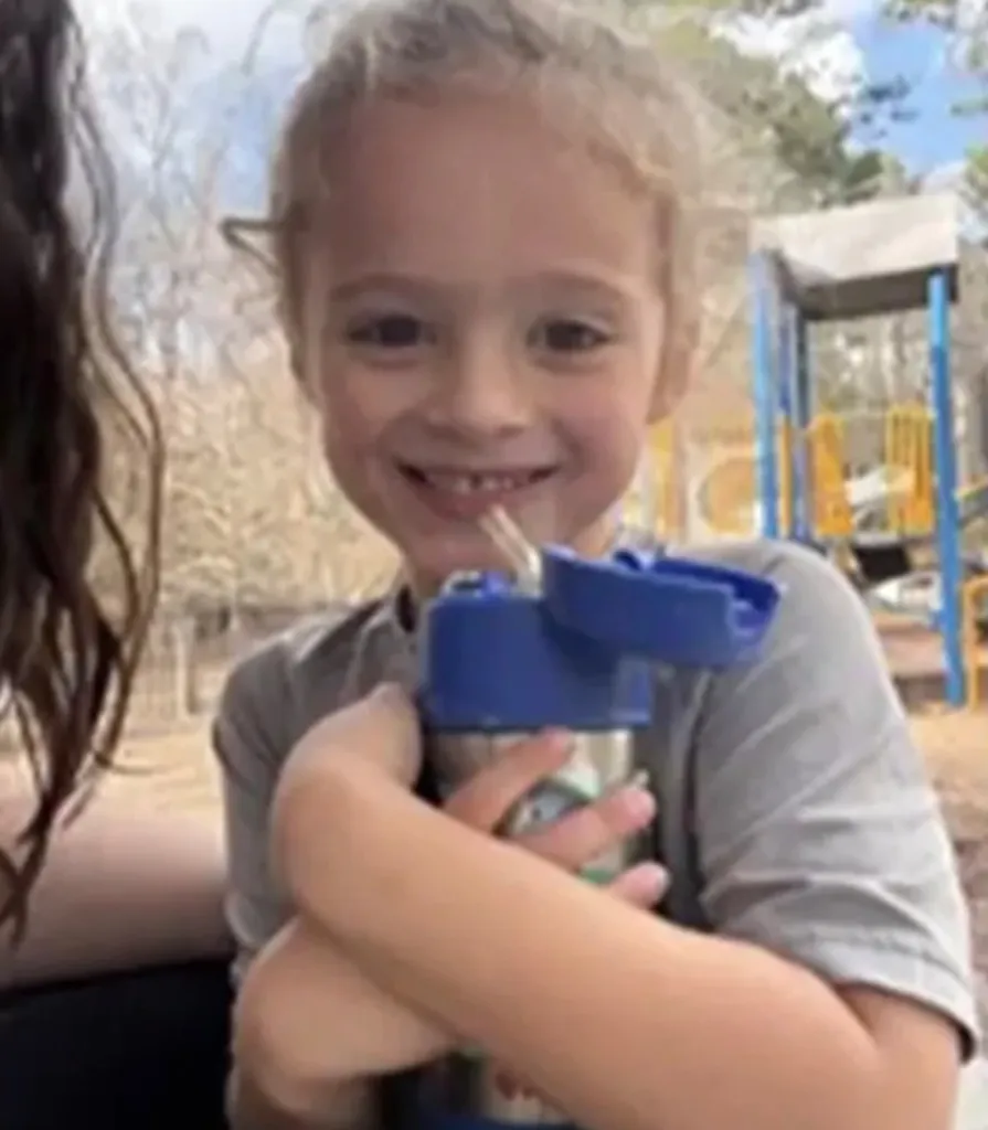 Johnathan Boley, a missing 4-year-old boy, smiling while holding a water bottle.