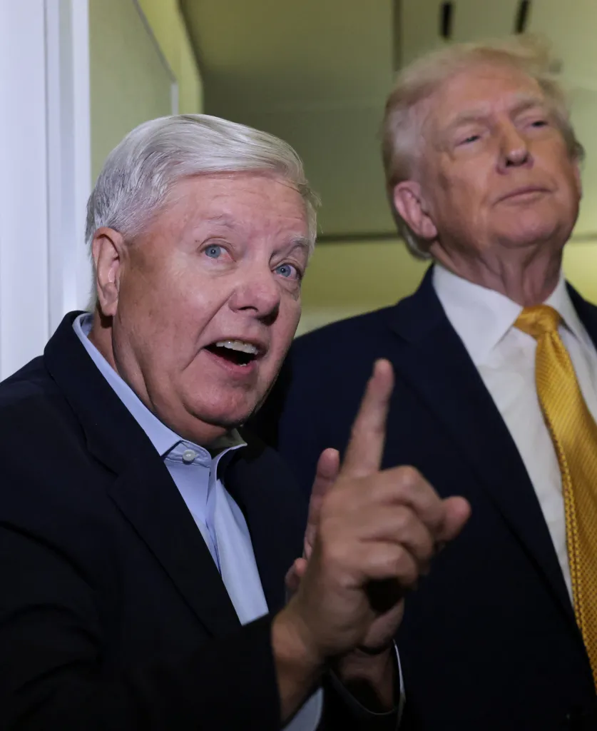 Senator Lindsey Graham speaking to reporters while President Donald Trump stands next to him aboard Air Force One.