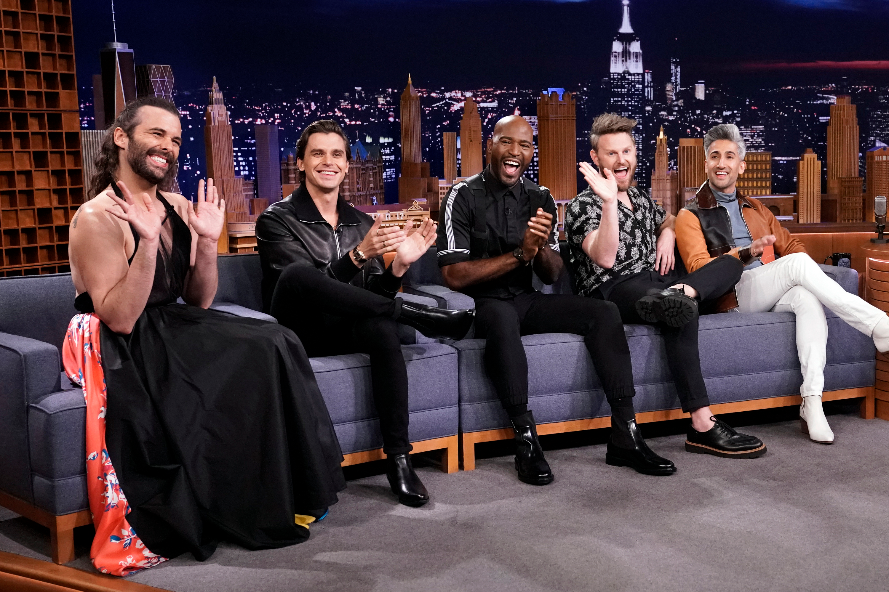 Jonathan Van Ness, Antoni Porowski, Karamo Brown, Bobby Berk, and Tan France of Queer Eye's Fab Five wave on a talk show.