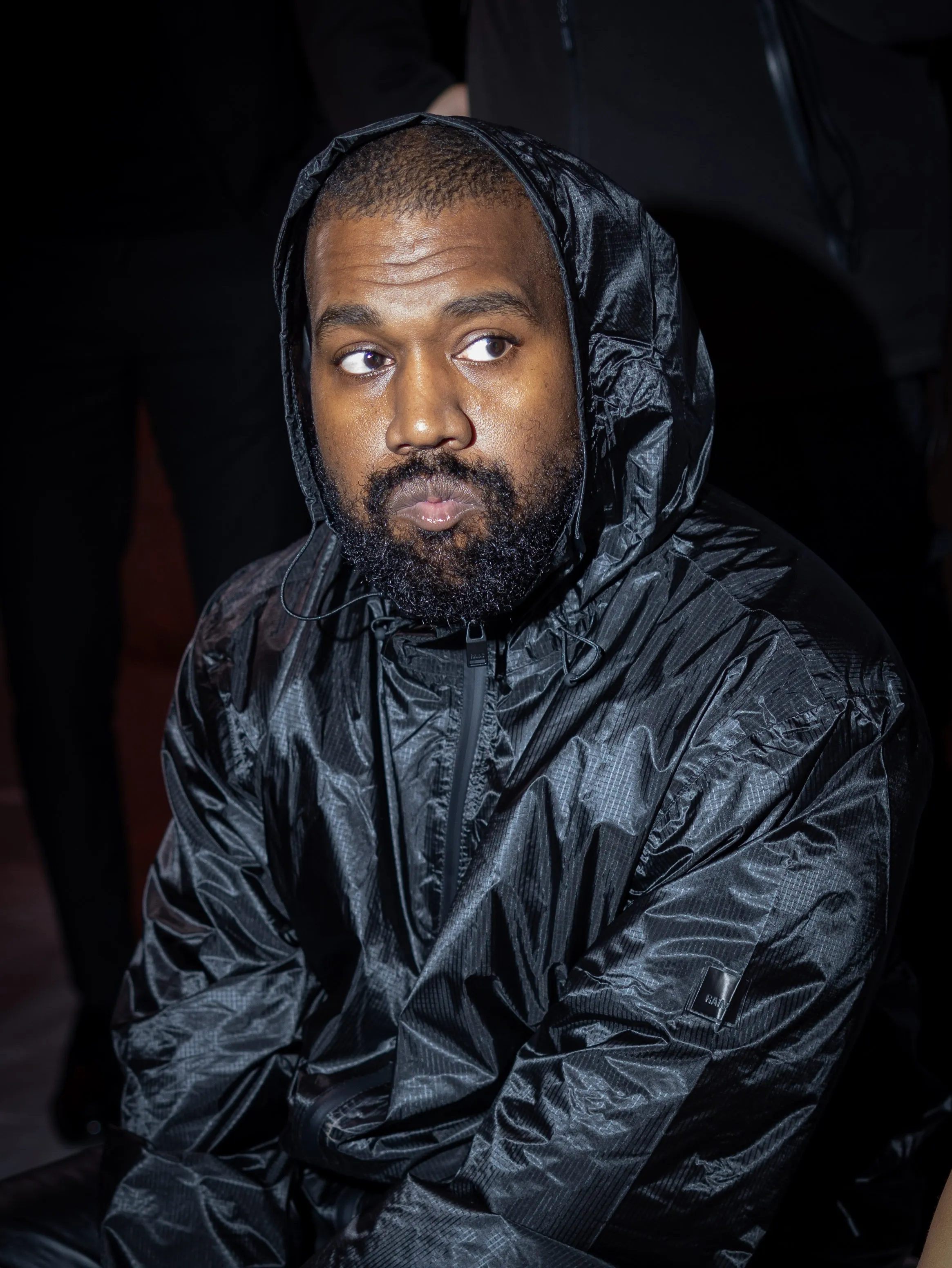 Kanye West in a black hooded jacket at Marni Fashion Show.