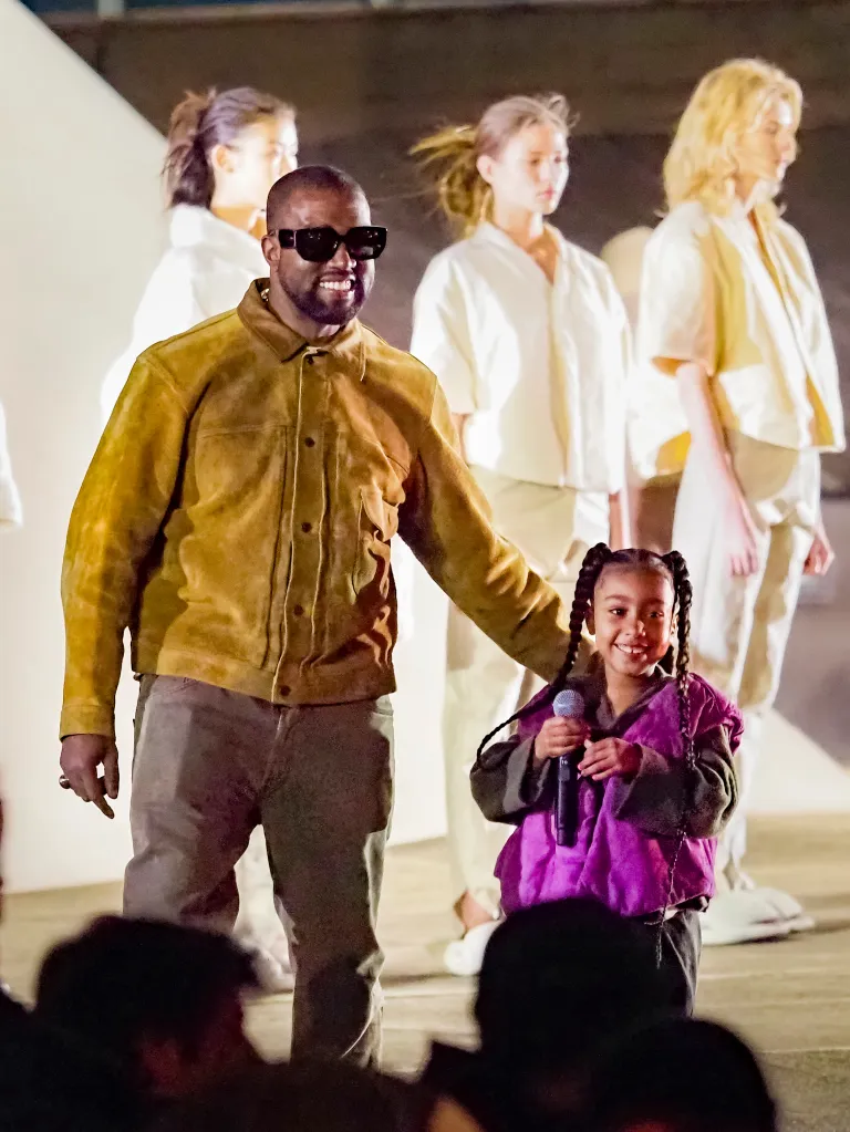 Kanye West and daughter North West attend the Yeezy Season 8 show.