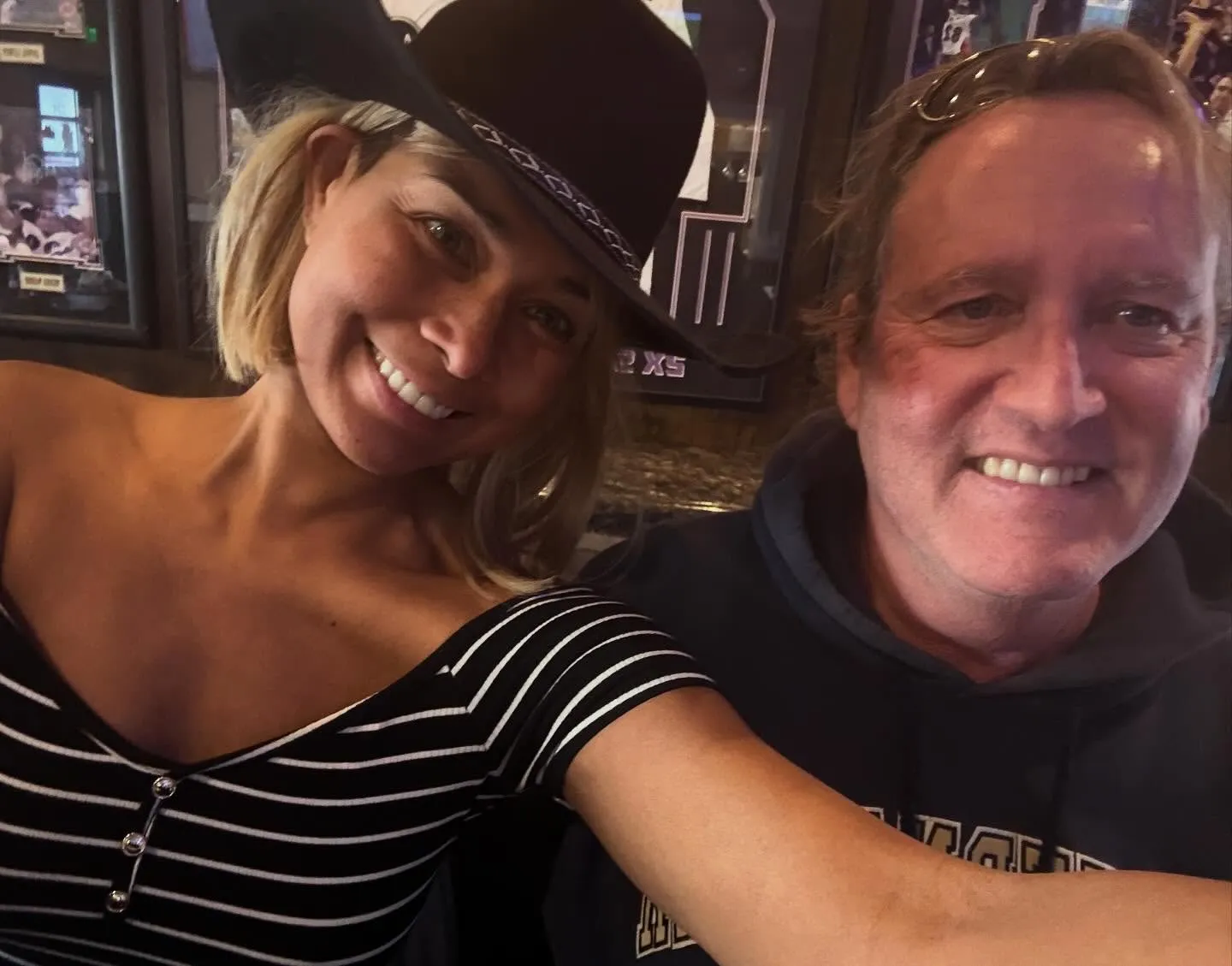 Katie Rost and husband smiling at the camera.