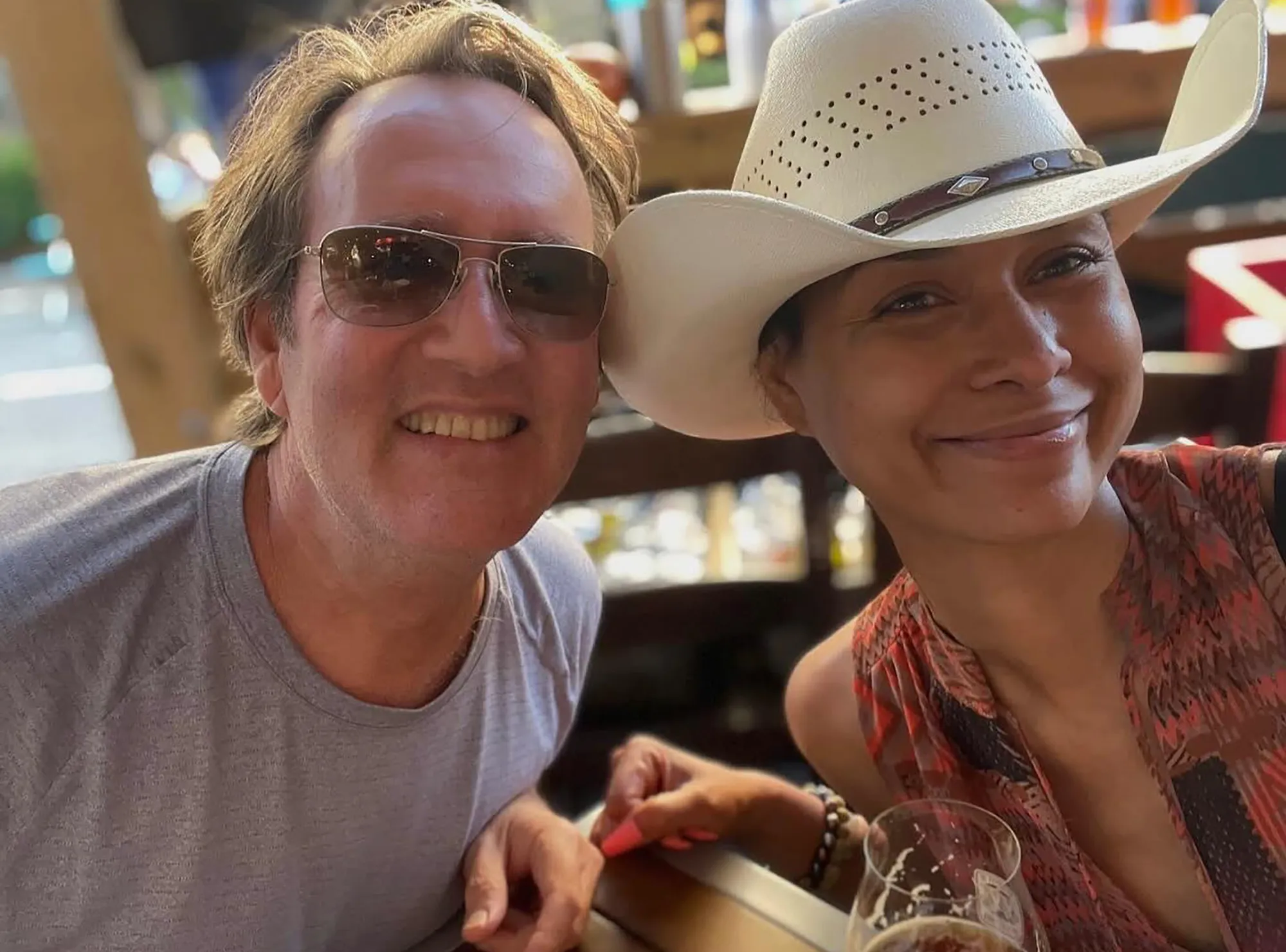 Katie Rost and her husband smiling at the camera.