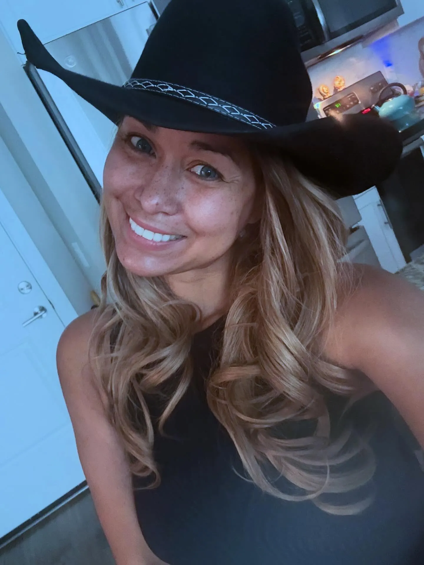 Katie Rost in a black cowboy hat.