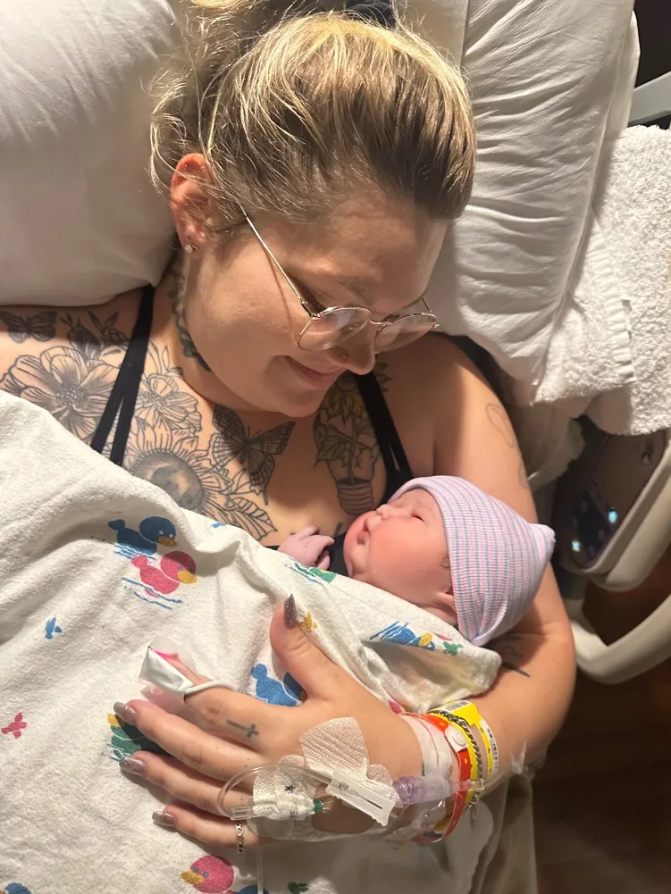 Kayla Elliot and a baby girl she delivered through surrogacy .