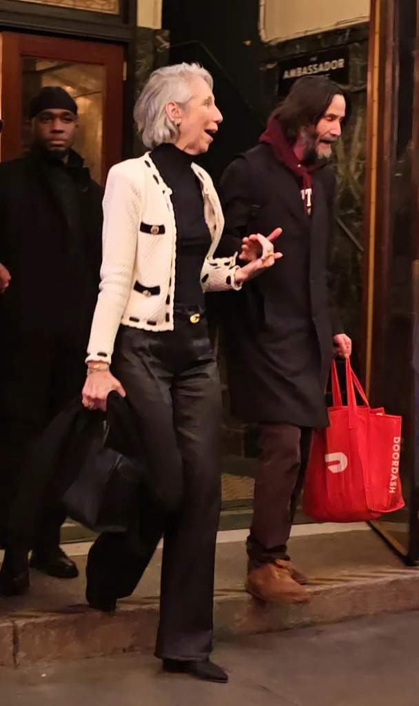 Keanu Reeves and Alexandra Grant exiting a theater.