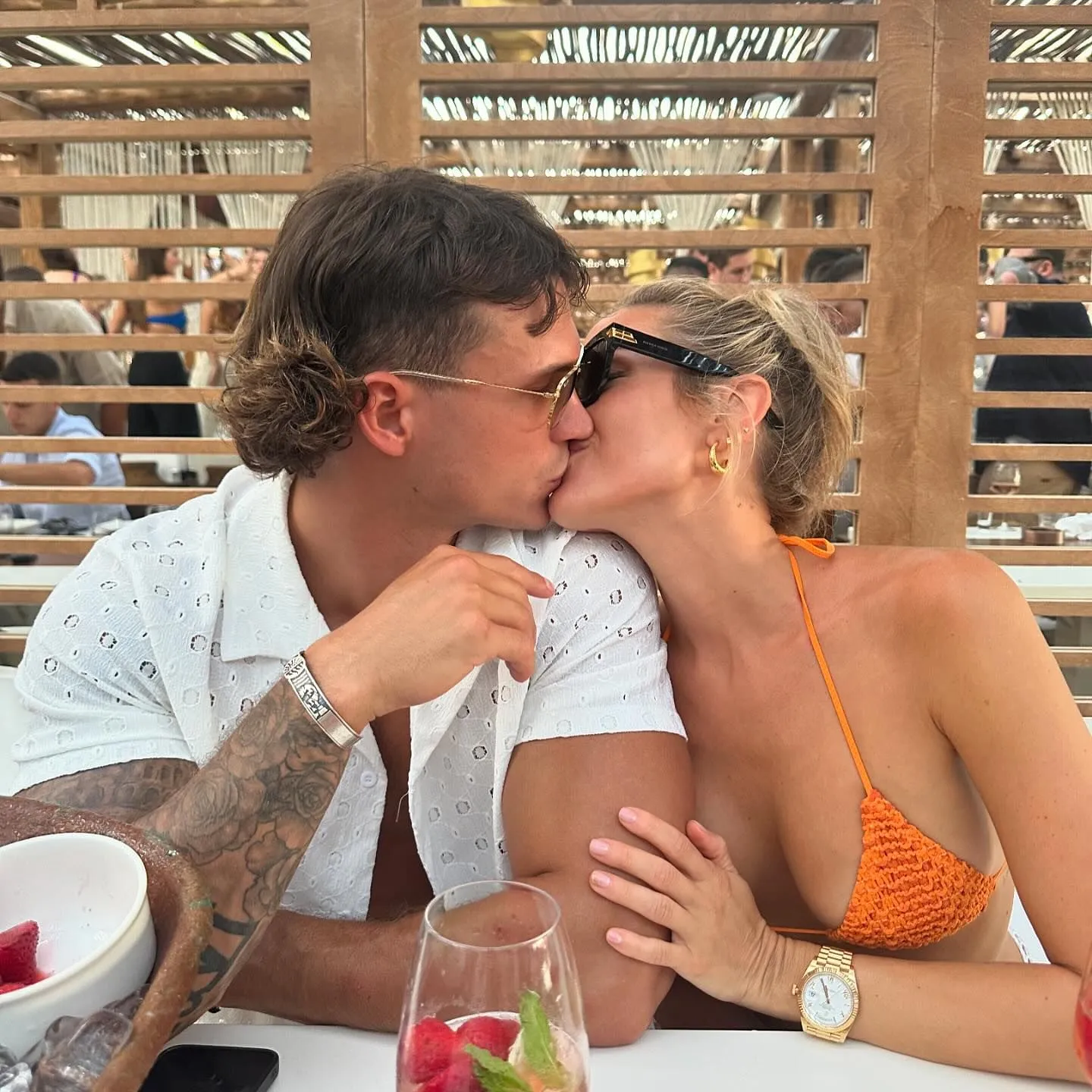 Kristin Cavallari and Mark Estes kissing at a restaurant.