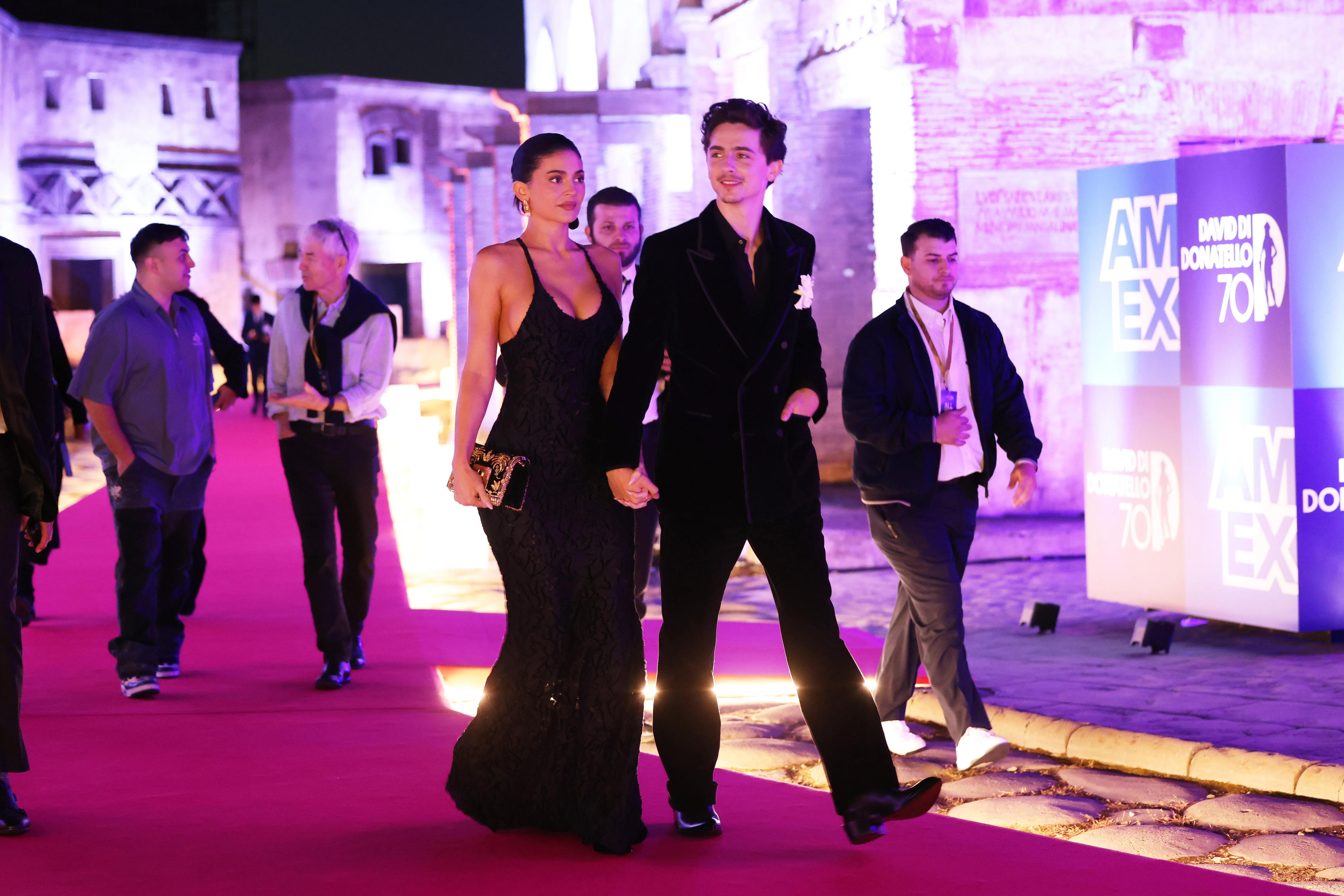 Kylie Jenner and Timothée Chalamet hold hands on a red carpet.