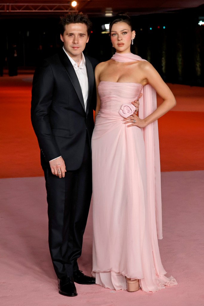 Brooklyn Beckham, in a black suit and white shirt, and Nicola Peltz, in a pink gown and scarf, attend the 3rd Annual Academy Museum Gala.