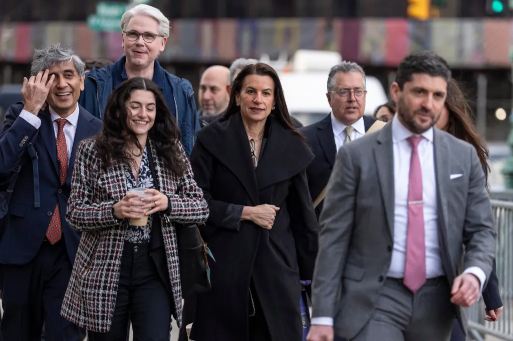 Karen Friedman Agnifilo, center, and Marc Agnifilo, second from right, walk in front of Manhattan federal court.