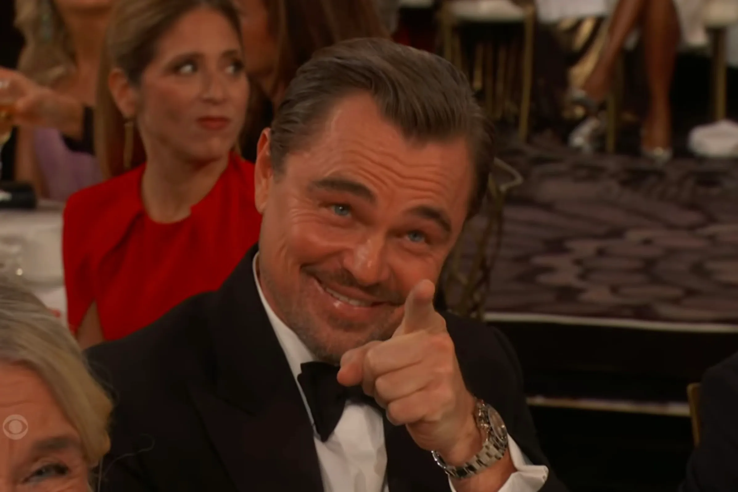 Leonardo DiCaprio pointing and smiling at the 83rd Annual Golden Globe Awards.