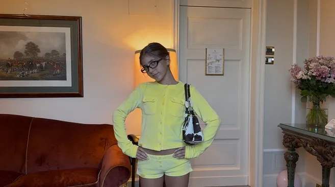 Kourtney Kardashian's daughter Penelope Disick poses in a yellow outfit.