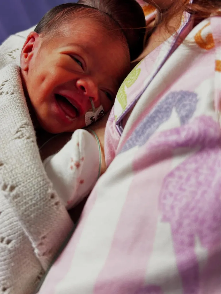 Jesy Nelson's baby in a hospital bed with a tube inserted into the nose.