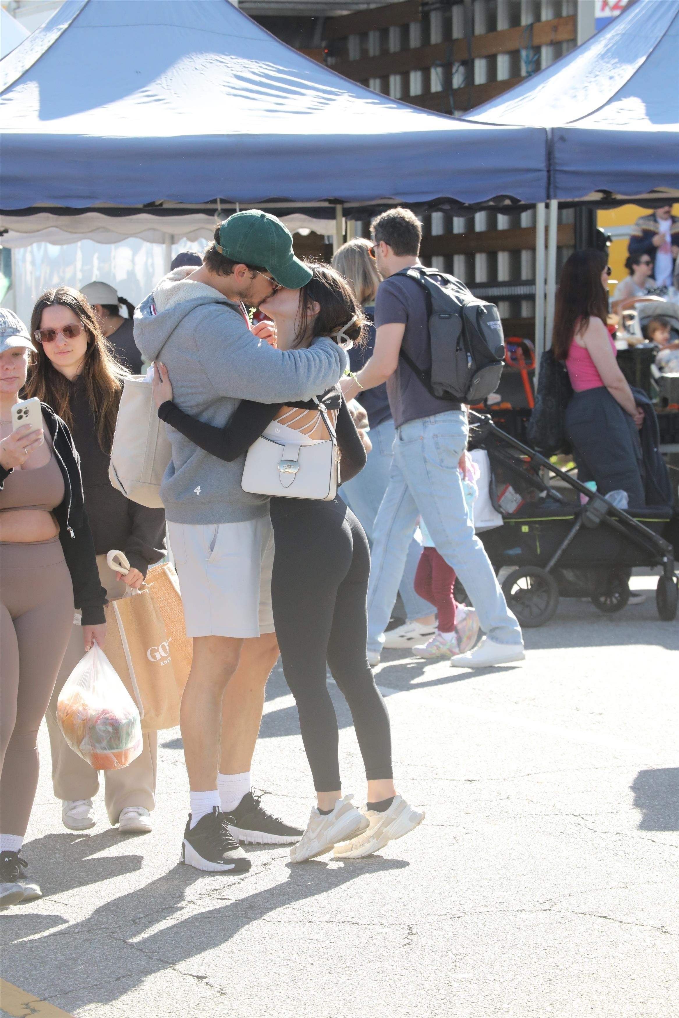 Gleb Savchenko and a mystery woman kiss at a farmers market.