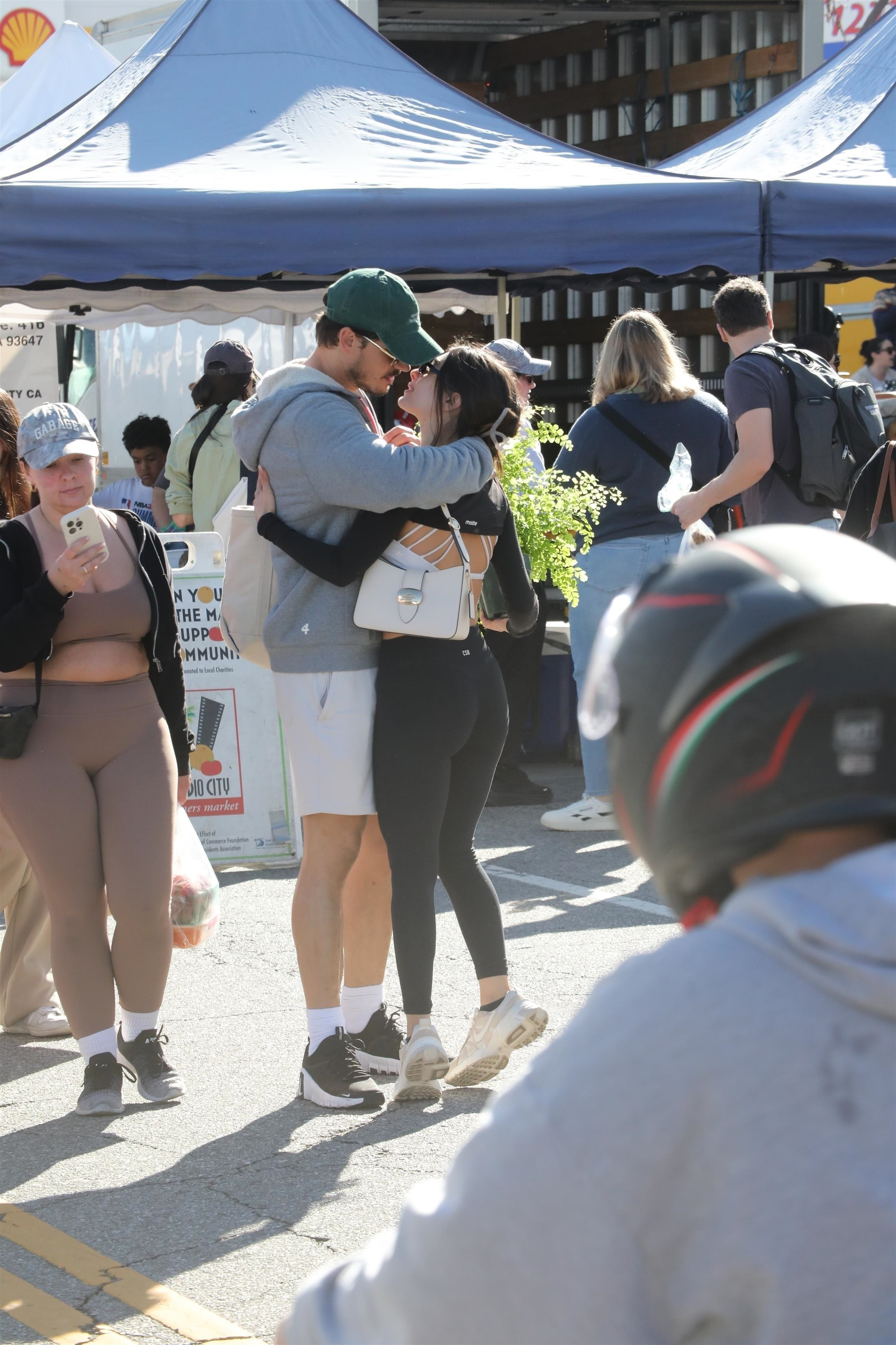 Gleb Savchenko embracing a mystery woman at the Studio City farmers market.