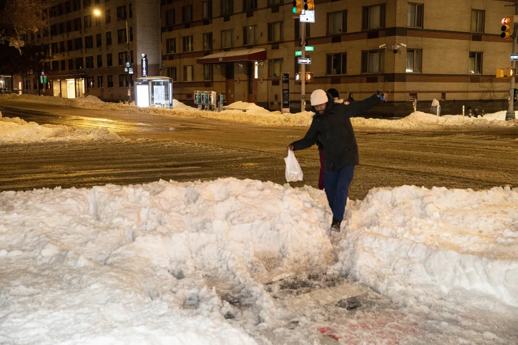 A man negotiates mounds of snow on 34th St. and 1st Ave. in Manhattan, Monday.