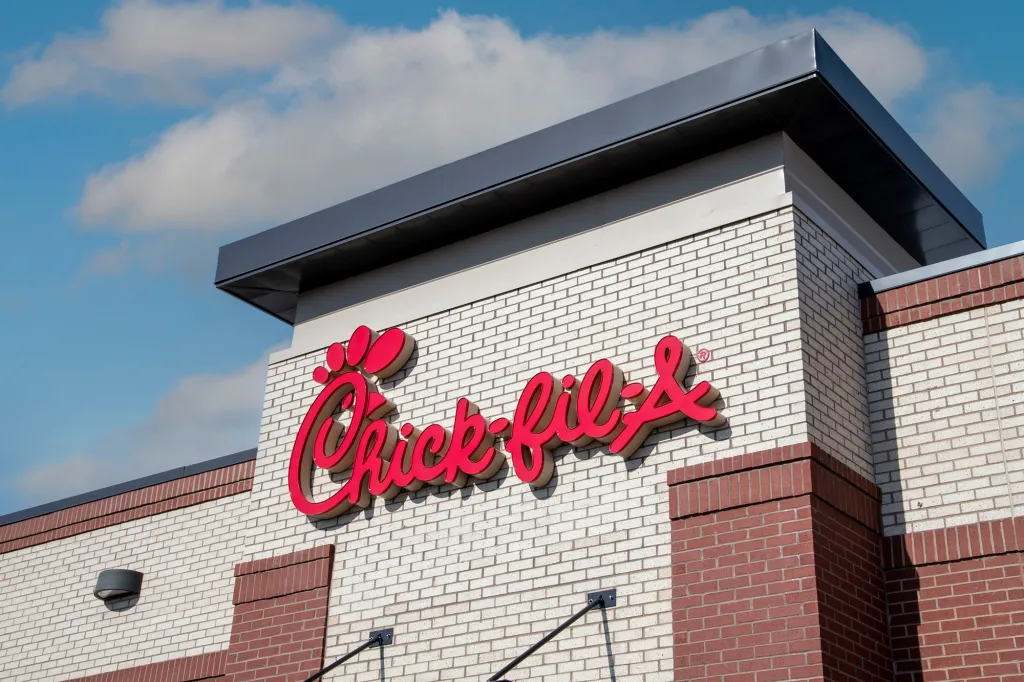 Chick-fil-A logo on a brick restaurant building.