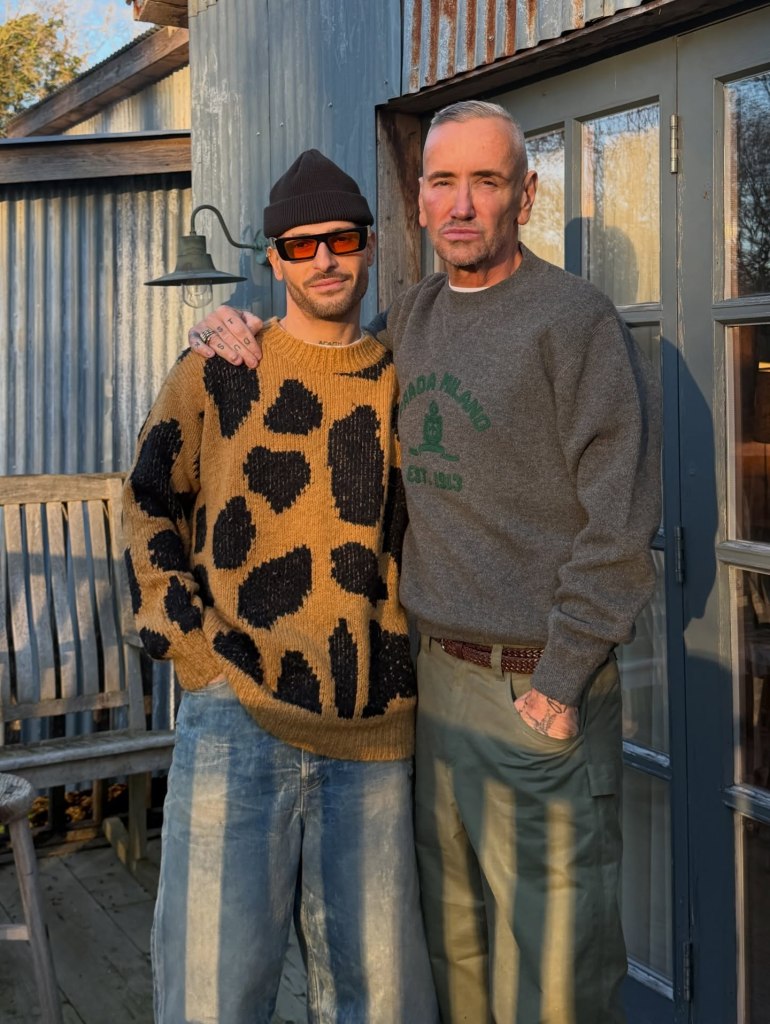 Stavros Agapiou and DJ Fat Tony, a married couple, posing together outdoors for their holiday card.