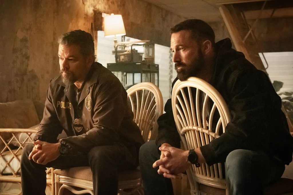 Matt Damon and Ben Affleck sitting, looking contemplative.