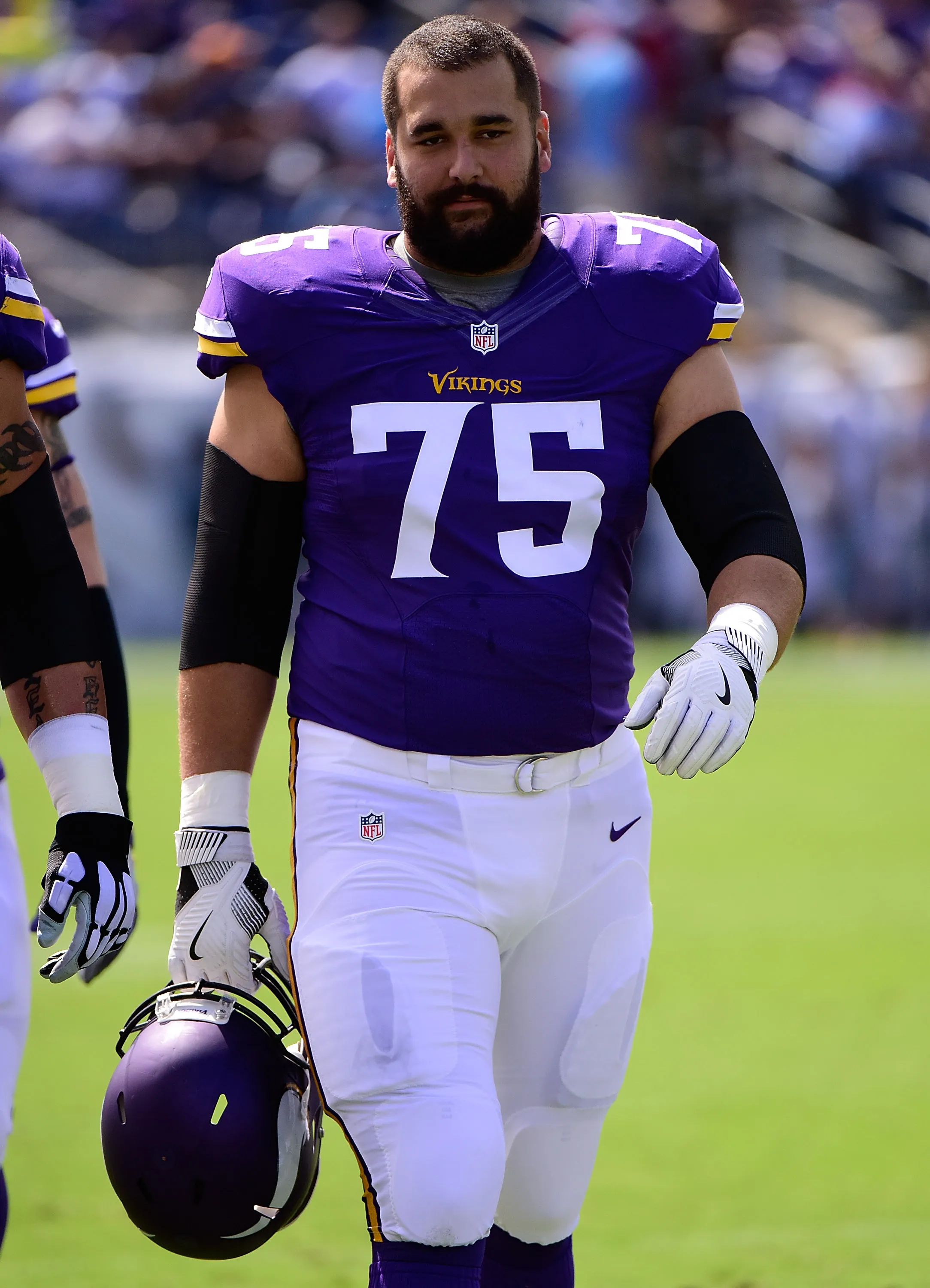 Matt Kalil in a Minnesota Vikings uniform, holding his helmet.