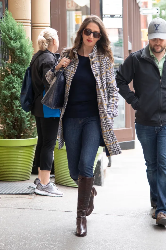 Brooke Nevils walking with her boyfriend Luke Thompson, who is out of frame on the right, on a city street.