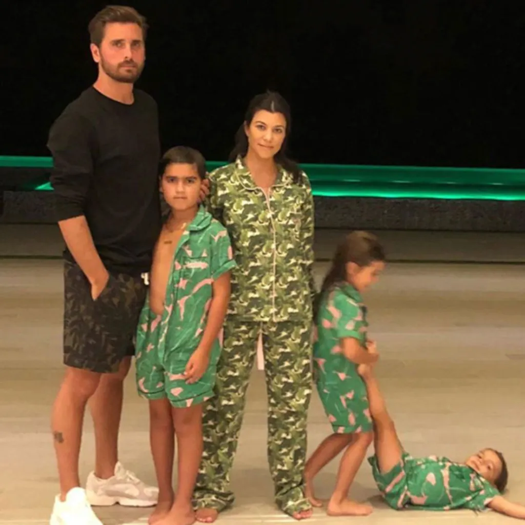 Scott Disick, Kourtney Kardashian, and their three children in matching pajamas.