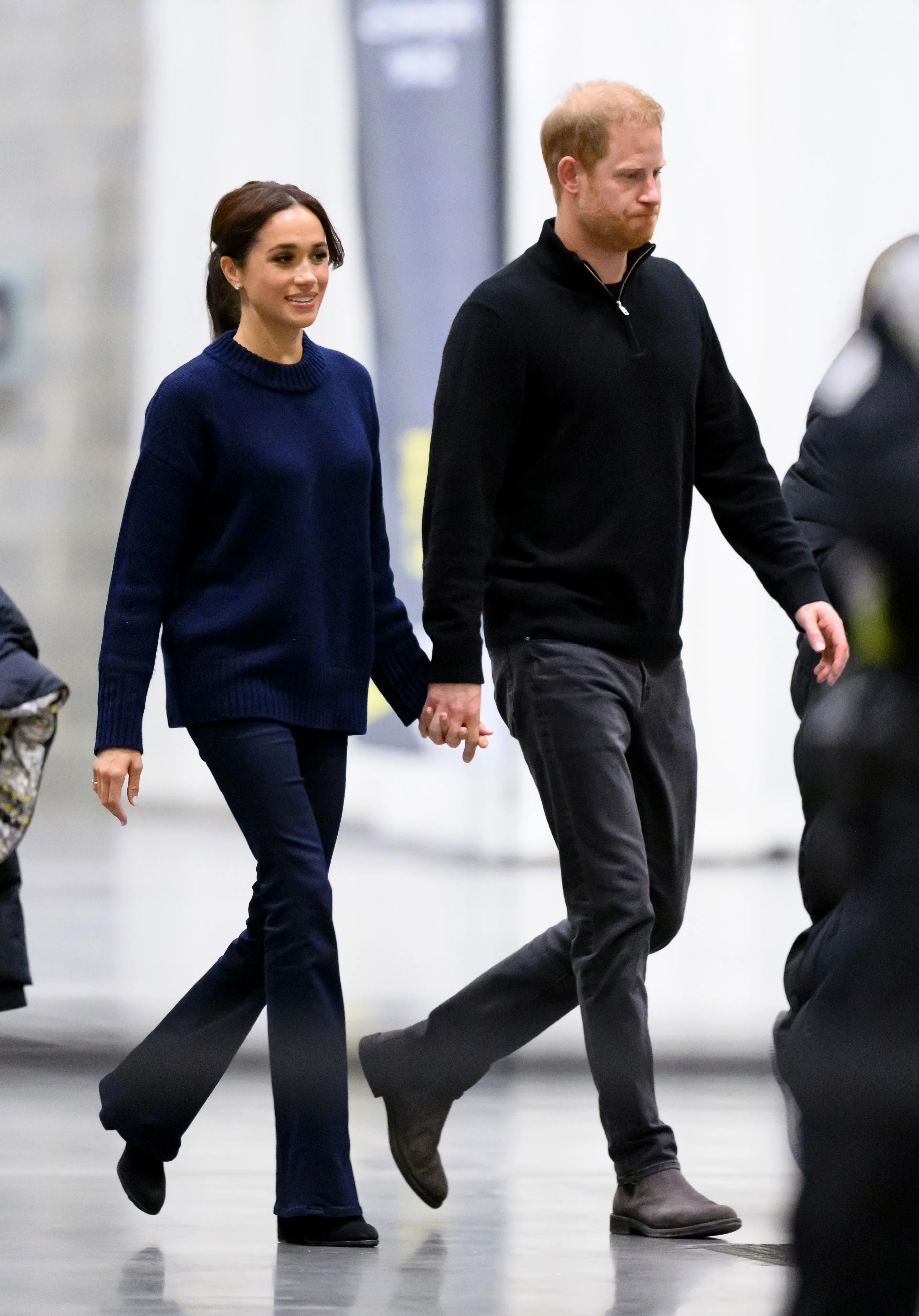 Meghan, Duchess of Sussex, and Prince Harry, Duke of Sussex, walk hand-in-hand at the 2025 Invictus Games.