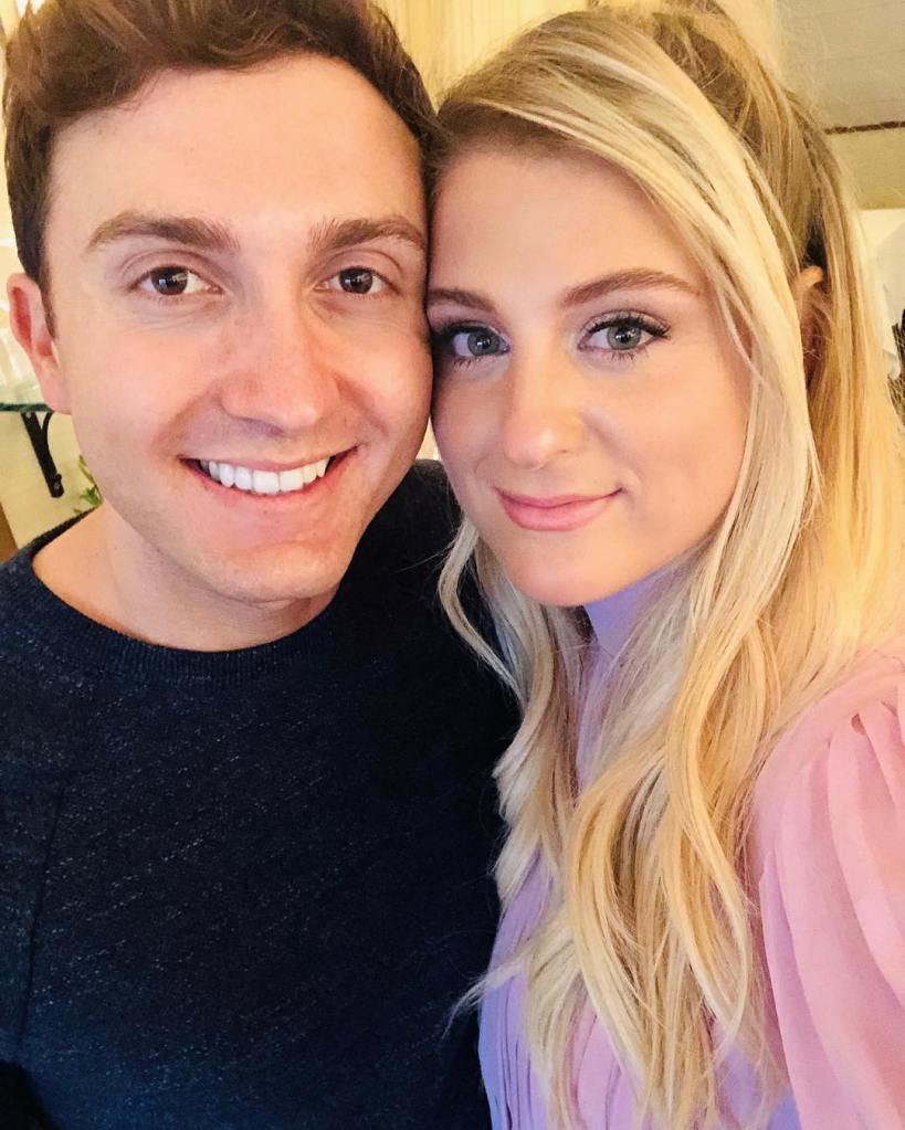 Meghan Trainor and husband Daryl Sabara smiling at the camera.