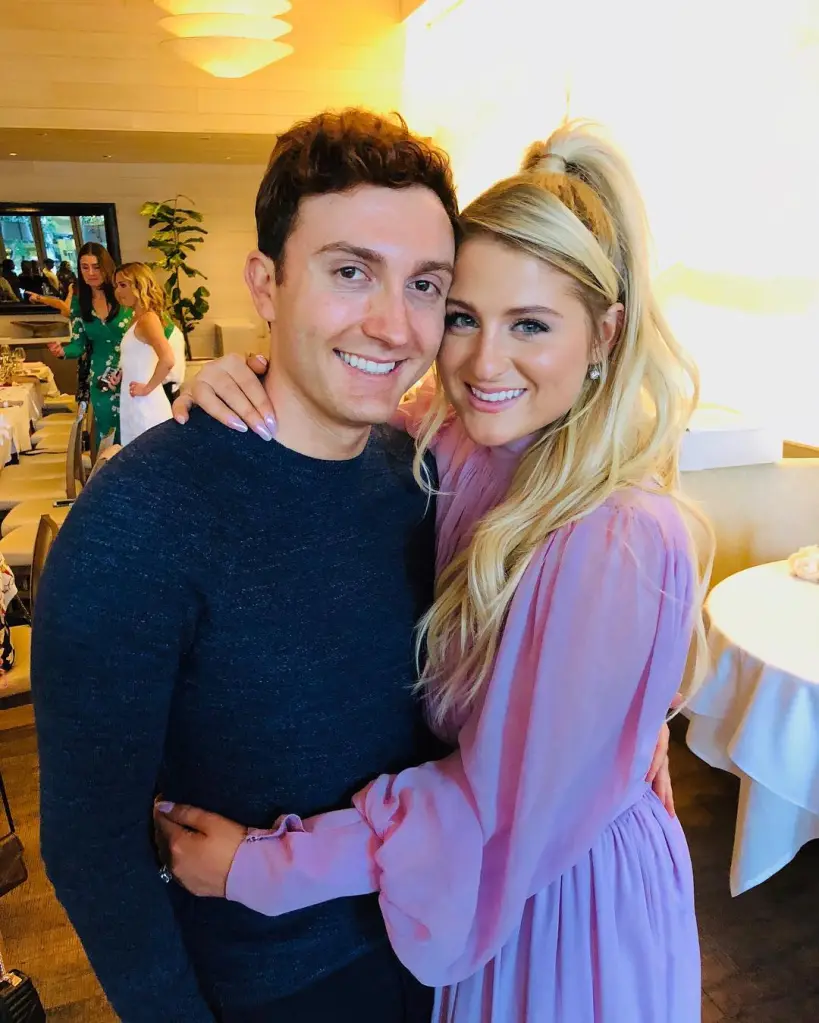 Meghan Trainor and husband Daryl Sabara embracing and smiling at the camera.