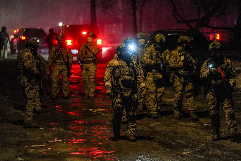 Members of law enforcement gather, as tensions rise after federal law enforcement agents were involved in a shooting incident, a week after a US Immigration and Customs Enforcement (ICE) agent fatally shot Renee Nicole Good, in north Minneapolis, Minnesota, on Jan. 14, 2026.