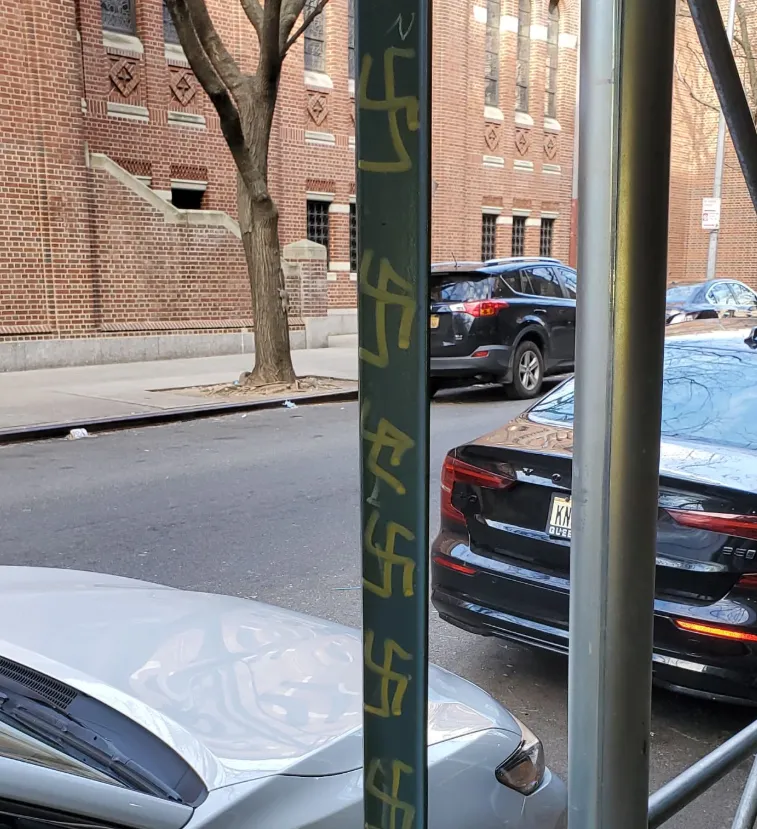 Swastikas seen scrawled on the side of a pole in Jackson Heights