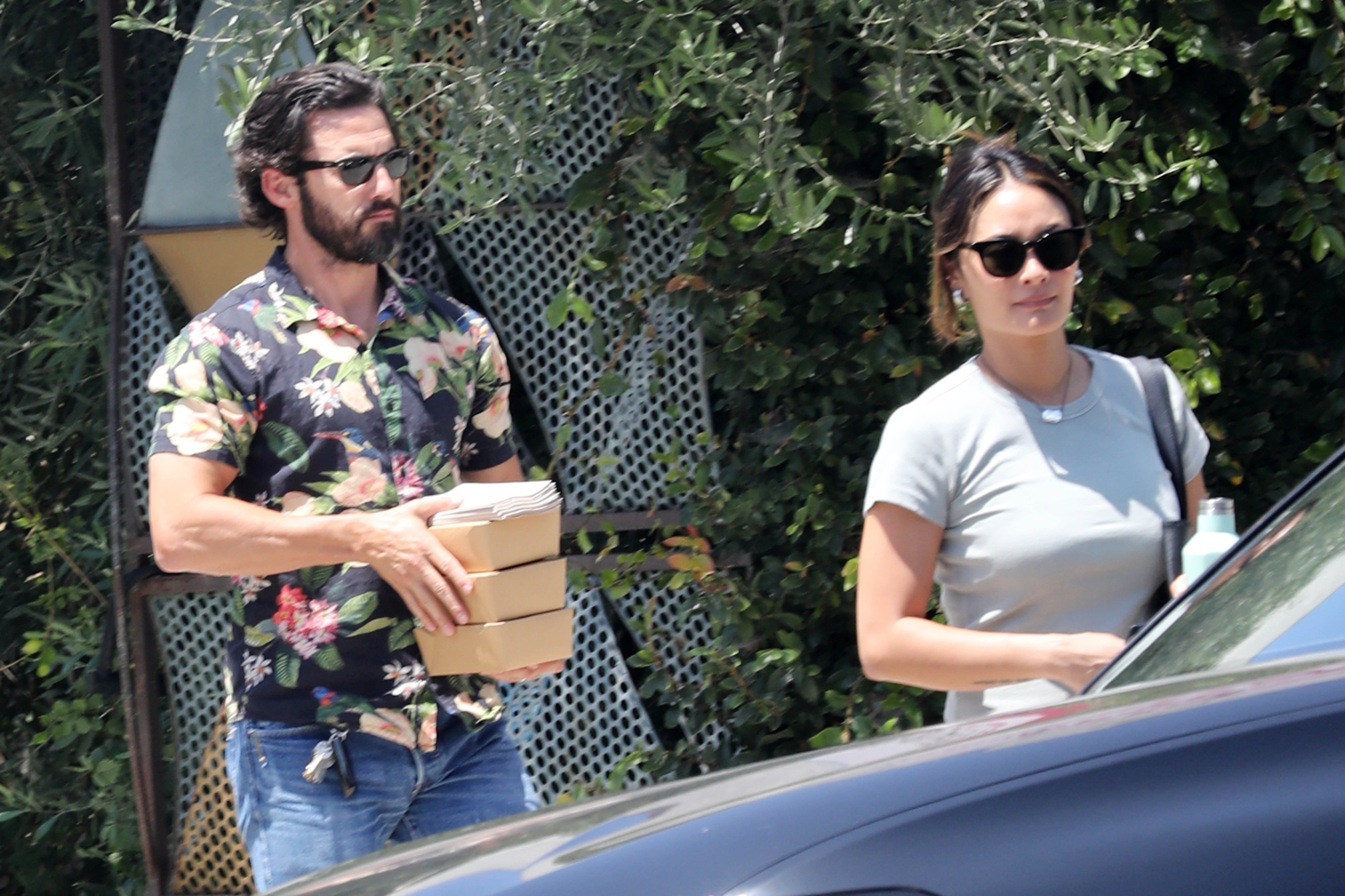 Milo Ventimiglia and Jarah Mariano leaving lunch with takeout containers.