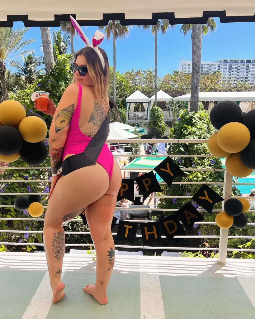 Kristin Haughton-James posing in a pink swimsuit with bunny ears and a drink in hand.