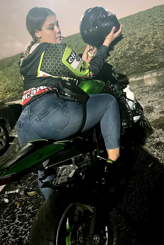 Kristin Elizabeth Haughton-James on a motorcycle, holding a helmet.