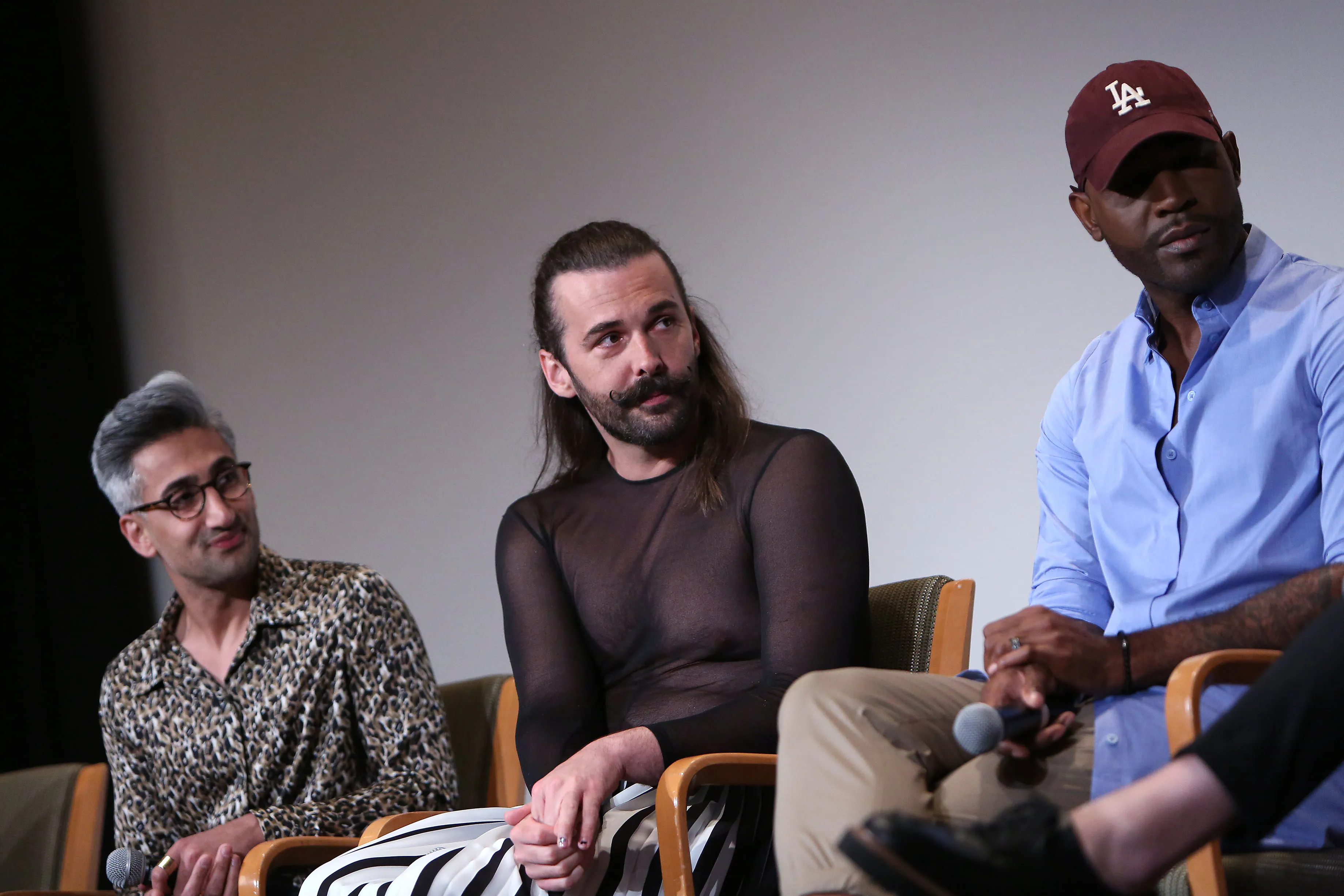 Tan France, Jonathan Van Ness, and Karamo Brown sitting on stage during the Netflix FYSEE Queer Eye season three screening.