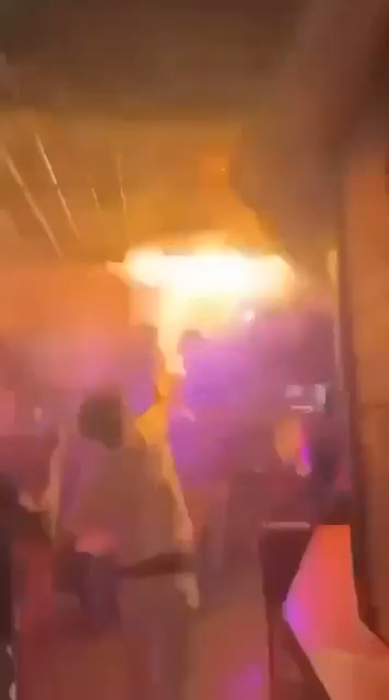 Flashover event with orange flames and dark smoke.