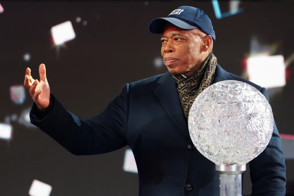 NYC Mayor Eric Adams stands beside the crystal button that triggers the descent of the Times Square New Year's Eve Ball on Dec. 31, 2025.