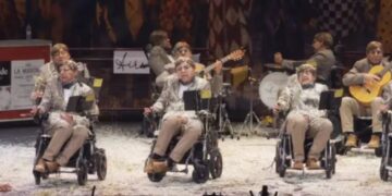 Spanish carnival group dress like Stephen Hawking, zip around in wheelchairs in bizarre performance to raise ALS awareness