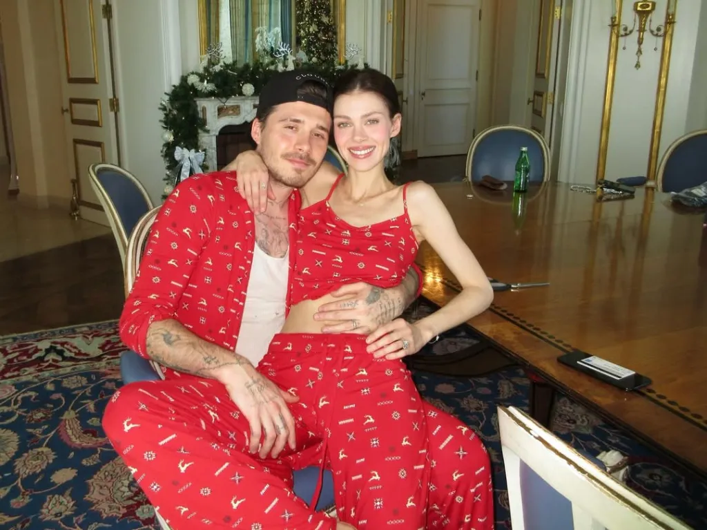Nicola Peltz Beckham and Brooklyn Beckham pose in matching Christmas pajamas.