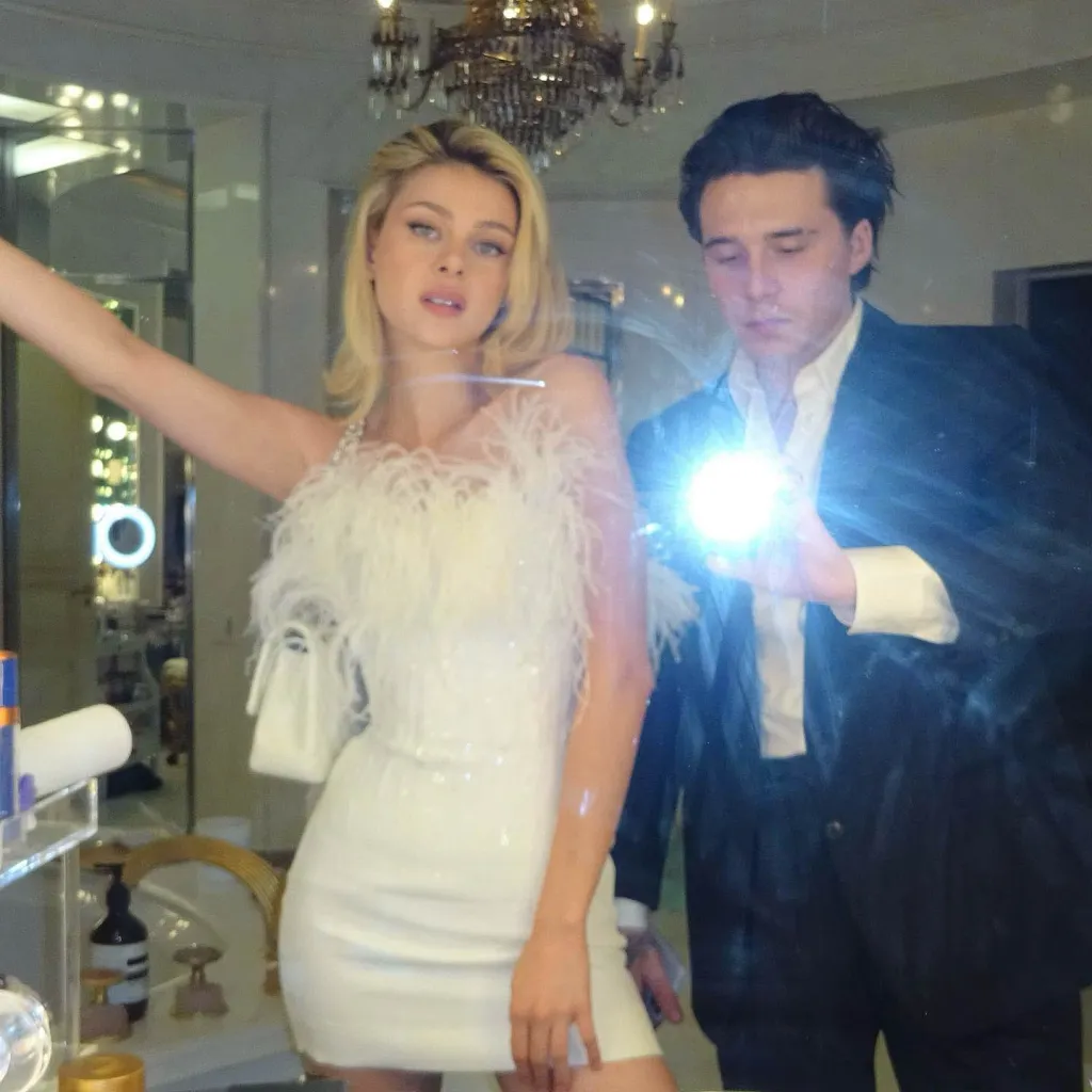 Nicola Peltz and Brooklyn Beckham reflected in a mirror.