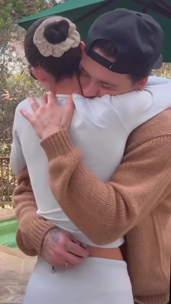 Nicola Peltz and Brooklyn Beckham embracing.