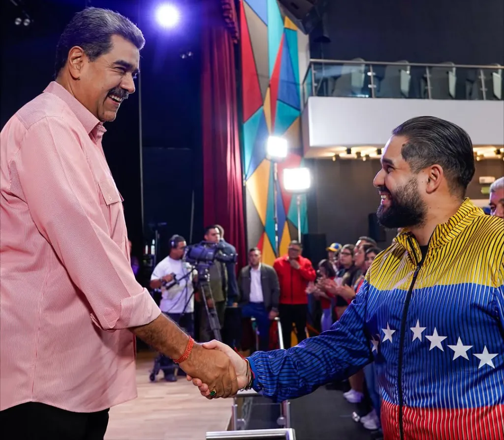 Nicolas Maduro Guerra shakes hands with his father President of Venezuela Nicolas Maduro.