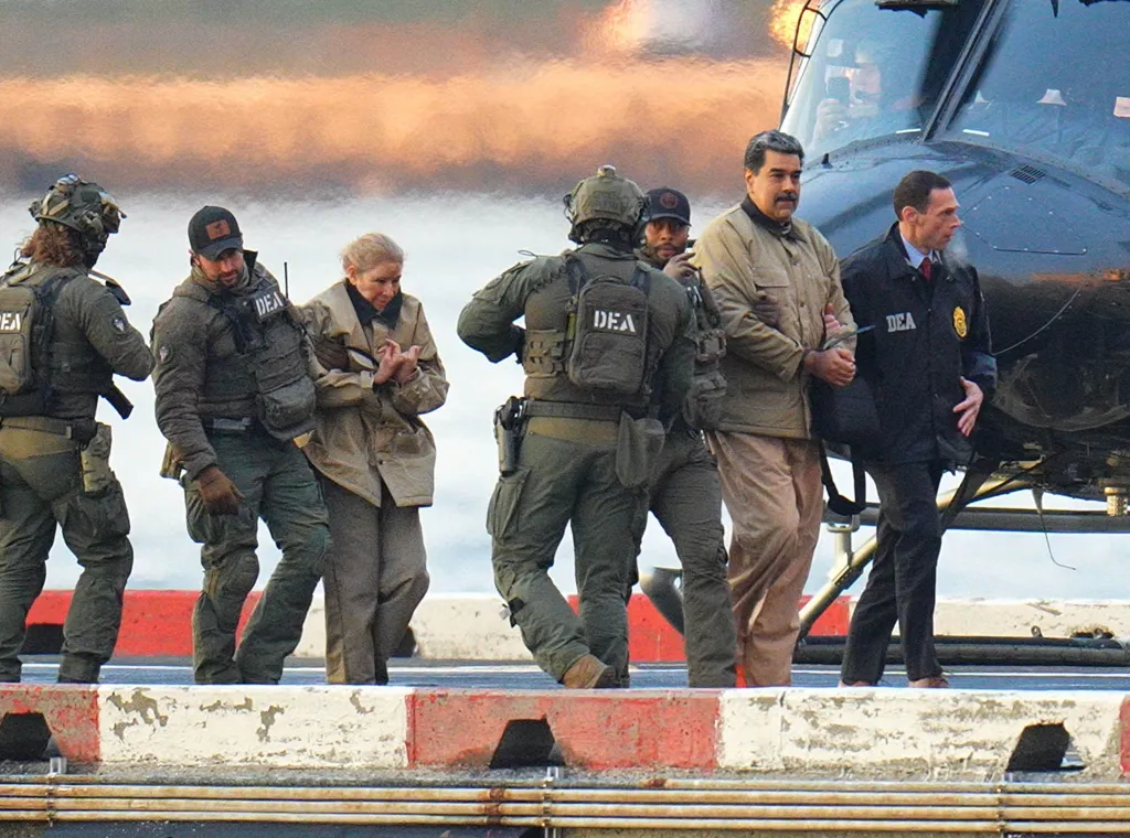 Nicolas Maduro and his wife, Cilia Flores, are escorted in handcuffs by DEA agents after landing at a Manhattan helipad.
