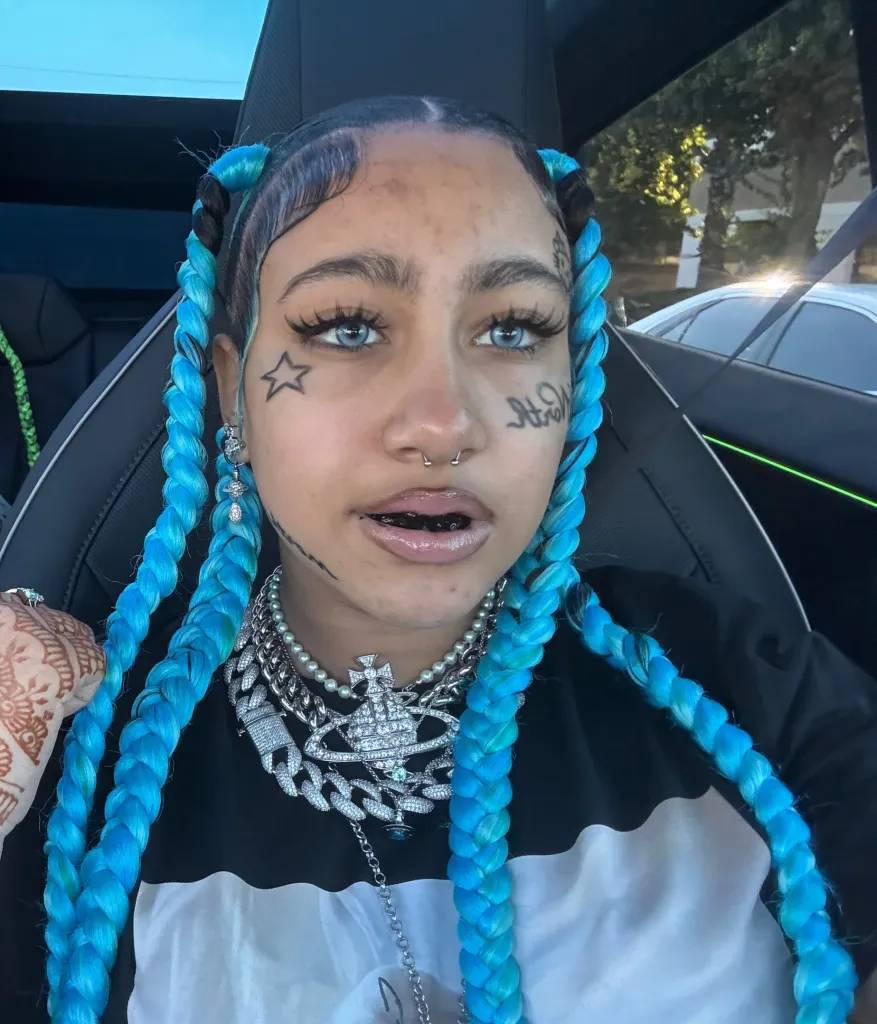 North West on TikTok wearing a black grill covering her teeth.